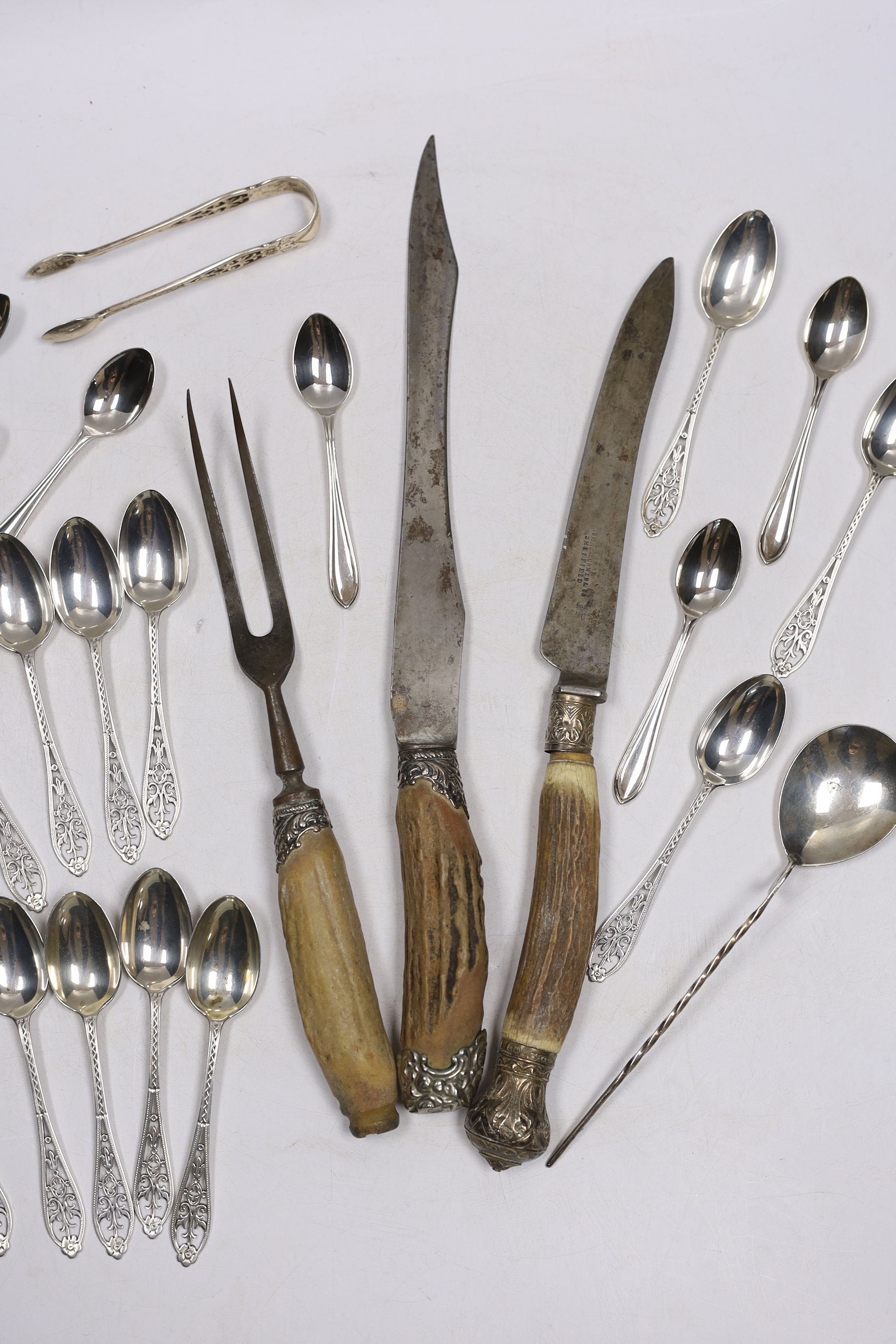 A set of twelve George V silver coffee spoons, with pierced handles, Josiah Williams & Co, London, 1912, 11.5cm, seven other silver spoons, a plated spoon and a three piece stag horn handled carving set.
